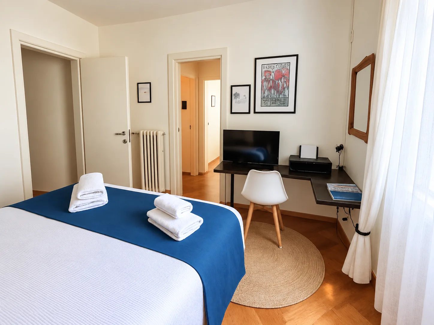 Bedroom with desk, TV and door to the hallway